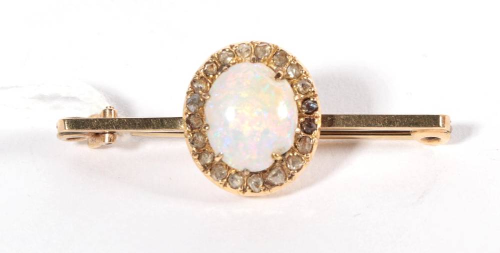 Lot 215 - An opal and diamond cluster bar brooch, to a 9 carat gold bar, measures 4cm long (opal...