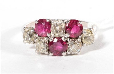 Lot 217 - An early twentieth century ruby and diamond ring, of two rows of alternating old cut diamonds...