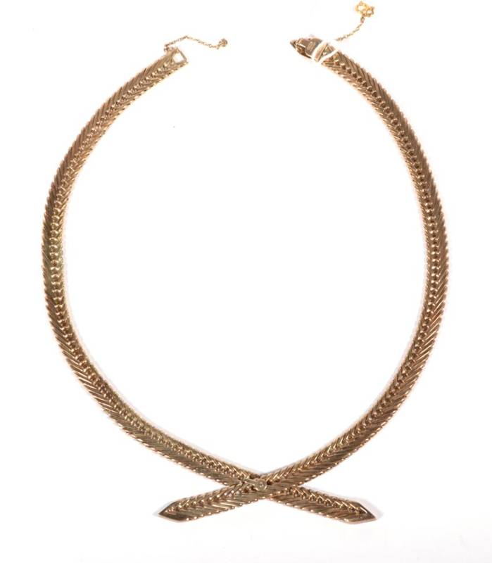 Lot 222 - A 9 carat gold herringbone chain crossover necklace, 45.3g