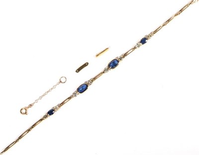 Lot 231 - A sapphire and diamond bracelet, four graduated oval cut sapphires spaced by round brilliant...