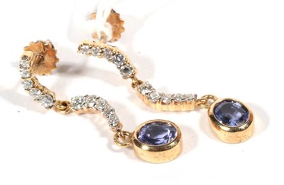 Lot 239 - A pair of tanzanite and diamond earrings, articulated scroll bars set with round brilliant cut...