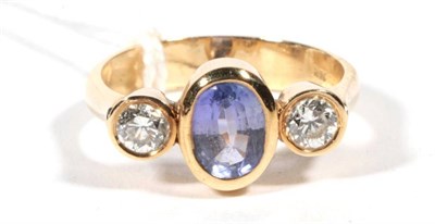 Lot 250 - A sapphire and diamond three stone ring, an oval cut sapphire spaced by round brilliant cut...