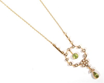 Lot 252 - ~ An early twentieth century peridot and seed pearl pendant necklace, a round cut peridot suspended