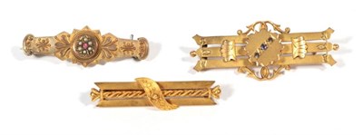 Lot 254 - Two Victorian 9 carat gold brooches; and another brooch stamped '15ct', 8.8g gross (3)