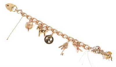 Lot 255 - A 9 carat gold fancy link charm bracelet, with six 9 carat gold charms and an 18 carat gold padlock