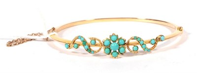 Lot 270 - ~ An early 20th century turquoise bangle, a floral cluster of turquoise between turquoise set...
