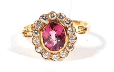 Lot 279 - A pink topaz and diamond cluster ring, an oval checkerboard cut pink topaz in a rubbed over...