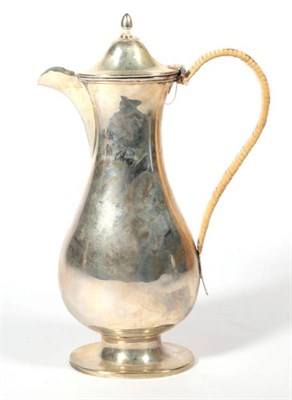 Lot 292 - ~ A late Victorian silver baluster hot water jug, by Goldsmiths & Silver smiths, London, 1899,...