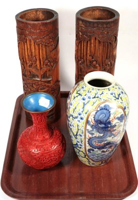 Lot 312 - A pair of carved bamboo spill vases; a Japanese porcelain baluster vase; and a lacquer baluster...