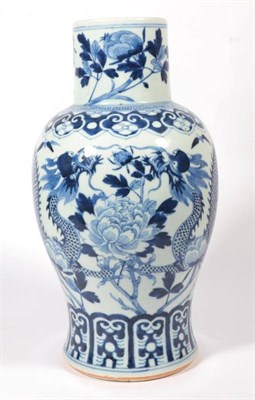 Lot 324 - A Chinese blue and white baluster porcelain vase, decorated with a trailing dragon amongst...