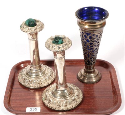 Lot 335 - ~ A pair of Edwardian silver candlesticks, by Martin & Hall, Birmingham, 1906; a pierced silver...