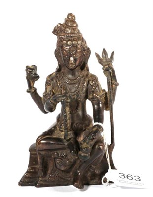 Lot 363 - A Chinese or South East Asian bronze figure of a seated deity