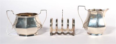 Lot 367 - A silver cream jug and sugar bowl of octagonal baluster form; and a silver toastrack (3)