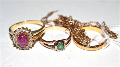 Lot 384 - A 22 carat gold band ring, finger size M, 3.2g; an emerald ring, 1.9g; a ruby cabochon and...