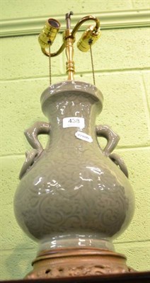 Lot 438 - A Chinese Celadon green glazed twin-handled vase, converted to a lamp, gilt mount and base,...