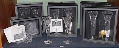 Lot 465 - A set of fourteen Waterford Crystal Millennium Collection champagne flutes and a matching set...