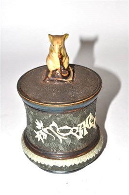 Lot 477 - ~ Royal Doulton Stoneware tobacco jar and cover by George Tinmouth, the lid decorated with a...