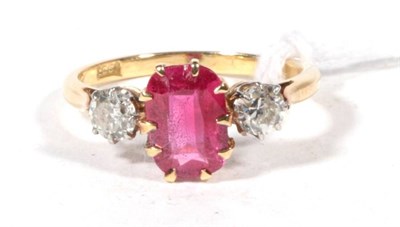 Lot 551 - A synthetic ruby and diamond three stone ring, a rectangular cushion cut synthetic ruby in a...