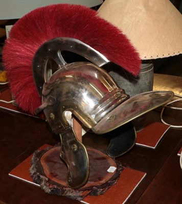 Lot 565 - A replica Roman Centurion's helmet, on stand, purchased at 'Authentic' in Rome