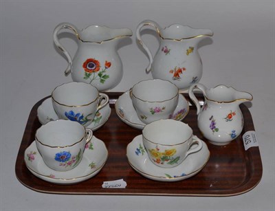 Lot 570 - Four Meissen floral decorated cups and saucers; two Meissen milk jugs; and a Meissen cream jug