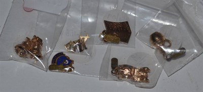 Lot 574 - Six various 9 carat gold charms, including; a kettle, a pair of wedding bells, a car, an enamel...