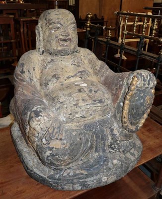 Lot 1153 - A large carved wooden seated Buddha, surface flaking, signs of original gilding, 61cm high