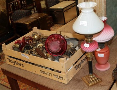 Lot 1165 - A pink satin glass oil lamp and shade; together with other lamps and plates