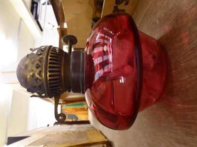 Lot 1165 - A pink satin glass oil lamp and shade; together with other lamps and plates