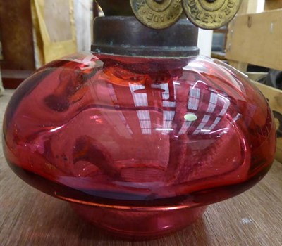 Lot 1165 - A pink satin glass oil lamp and shade; together with other lamps and plates