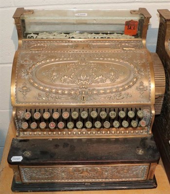 Lot 1205 - ~ A late Victorian brass national cash register, the case decorated with flower bells and...