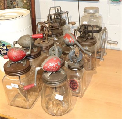 Lot 1222 - ~ Eleven assorted glass butter churns of assorted sizes some labelled Blow Butter Churn