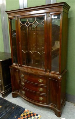 Lot 1305 - A reproduction mahogany bookcase in George III style, with glazed door between fluted stiles,...