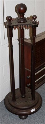 Lot 1309 - ~ A late Victorian mahogany revolving snooker cue stand with spindle supports and circular base...