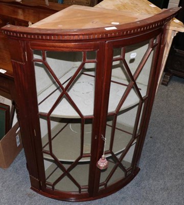 Lot 1314 - A mahogany bow fronted corner cupboard in the George III style and a reproduction mahogany...