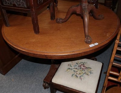 Lot 1319 - ~ A Victorian mahogany circular flip top dining table, mid 19th century, with a plain frieze...