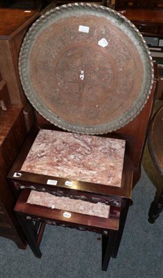 Lot 1327 - A Persian copper engraved tray and two marble topped nesting tables