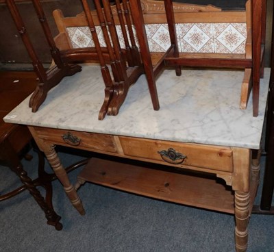 Lot 1335 - ~ A late Victorian pine marble top and tile back washstand with two drawers above spindle...