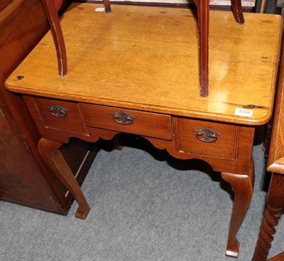 Lot 1338 - A George III oak dressing table with three drawers