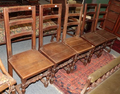 Lot 1364 - ~ A set of five joined oak dining chairs with boarded seats and turned block legs