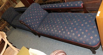 Lot 1371 - ~ A late Victorian mahogany framed chaise longue, circa 1900, recovered in blue fleur de lis...