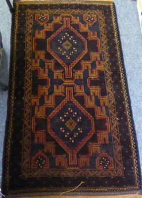 Lot 1380 - ~ Kashgai Carpet, South West Iran, the claret field with three medallions enclosed by narrow...