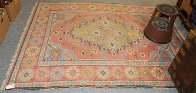 Lot 1387 - An Anatolian carpet, the terracotta field with apple green medallion framed by polychrome...