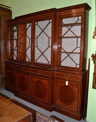 Lot 1414 - A 20th century mahogany, satinwood, crossbanded and ebony strung breakfront library bookcase,...