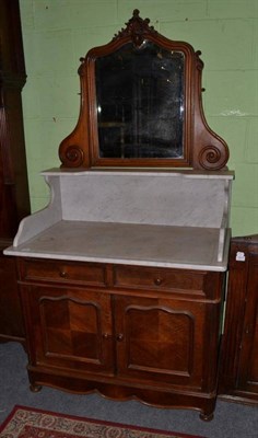 Lot 1418 - ~ A late 19th century Continental walnut washstand with grey and white marble top above two...