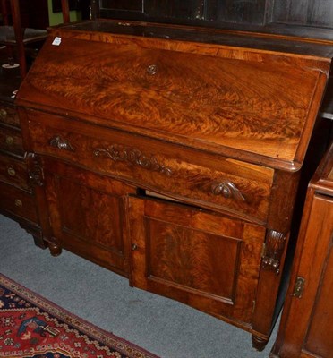 Lot 1427 - A mid-19th century mahogany bureau with fall front, above a serpentine shaped drawer with...