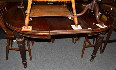 Lot 1453 - ~ An early 19th century mahogany circular extending dining table with one additional leaf raised on