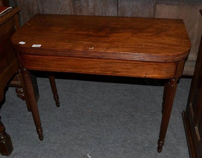 Lot 1465 - An early 19th century mahogany and boxwood strung fold over tea table, on reeded legs