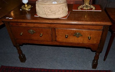 Lot 1466 - A George III oak dresser base fitted with two drawers