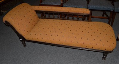 Lot 1483 - ~ A late Victorian oak framed chaise longue, recovered in geometric patterned fabric, with...