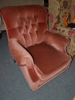 Lot 1494 - Modern pink velvet armchair, labelled Wade